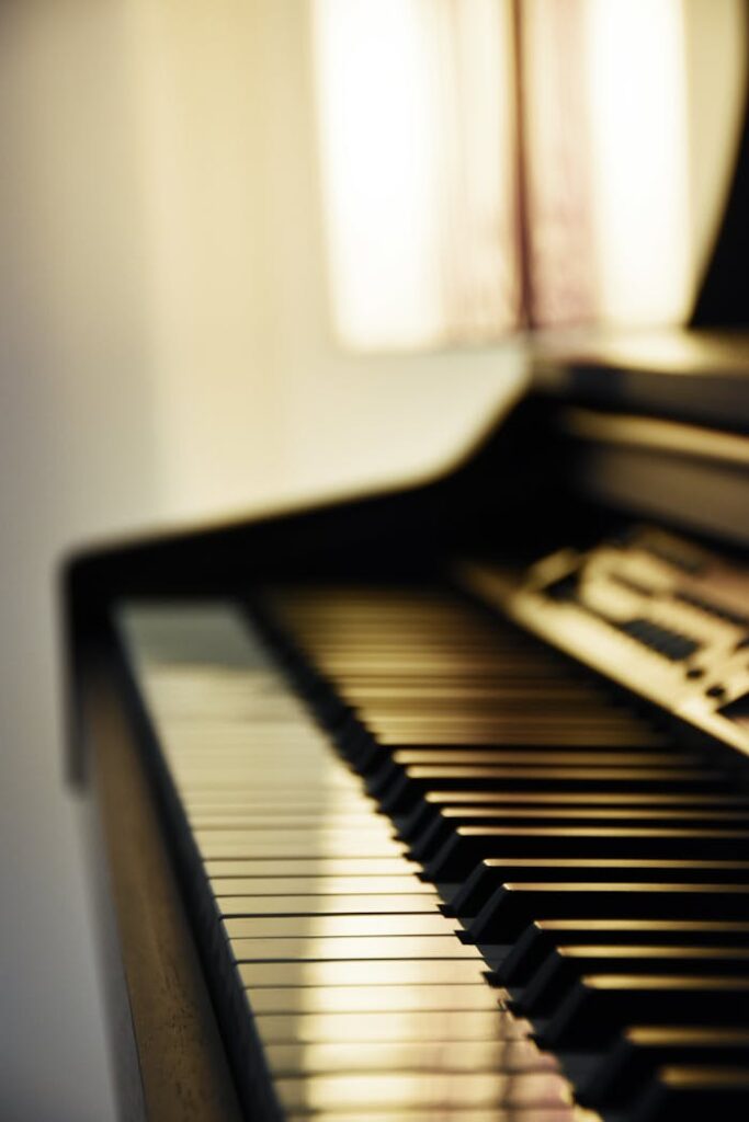 A close-up of grand piano keys bathed in soft light, showcasing elegance.